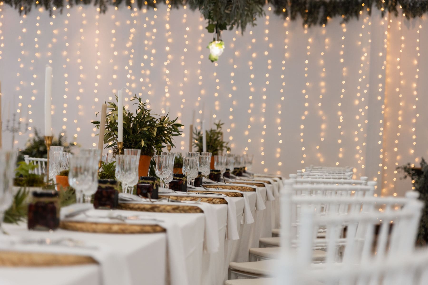 Romantic table setting with fairy light backdrop